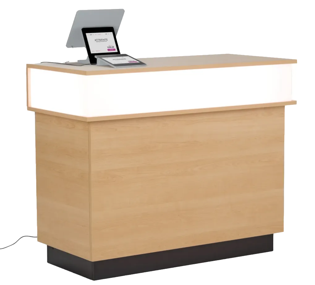 A light wood information counter with a glowing front panel, tablet, and display screen.